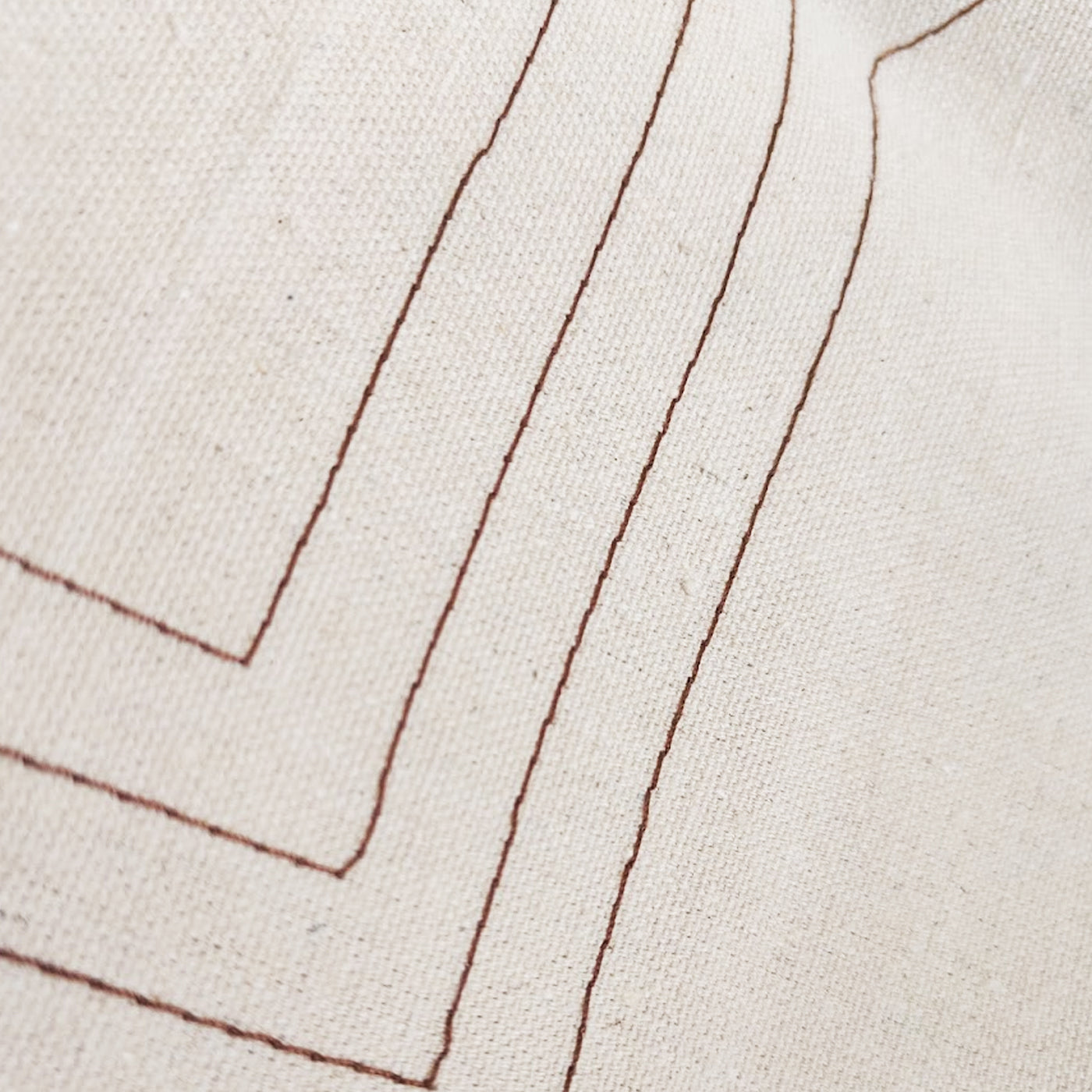 Close-up of fabric with brown stitching